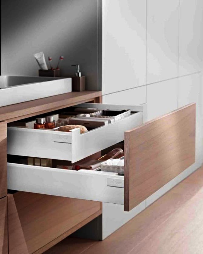 Two soft-close drawers pulled open, showing the slim white metal-sided drawer boxes fitted as standard behind a pale timber drawer front